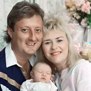 British darts player Eric Bristow poses at home with his wife Jane