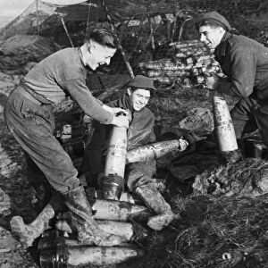 British Gunners Clark, Duggan and Wilson fusing shells before an attack in Germany