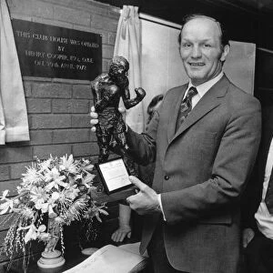 Former British Heavyweight champion boxer Henry Cooper holds a bronze statue of himself