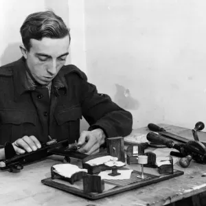 A British LAC enjoying spare time with a model aircraft kit. 7th December 1944