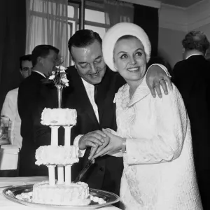 British musician Ronnie Ronalde cuts the cake with his new bride Yana after their wedding