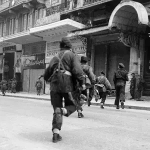 British paratroopers dash across a bullet swept street to storm a building in Athens British paratroopers dash across a bullet swept street to storm a building in Athens