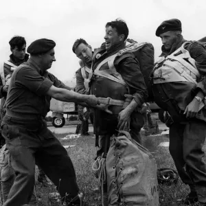 British Paratroops Army Soldiers August 1952 An officer tightens a chute for a British Paratroops Army Soldiers August 1952 An officer tightens a chute for a