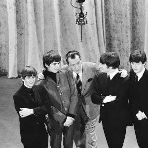 British pop group The Beatles with American talk show host Ed Sullivan on the set of his British pop group The Beatles with American talk show host Ed Sullivan on the set of his
