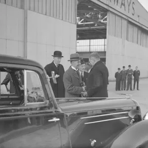 British Prime Minister Neville Chamberlain shakes hands with a German embassy official