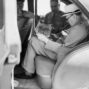 British Prime Minister Winston Churchill with American officers studying aerial British Prime Minister Winston Churchill with American officers studying aerial