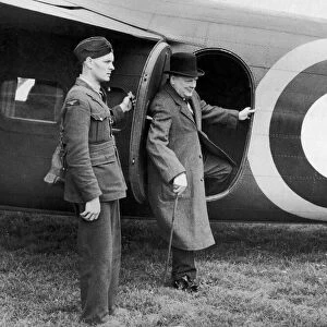 British Prime minister Winston Churchill leaves his aeroplane for a visit to a defence