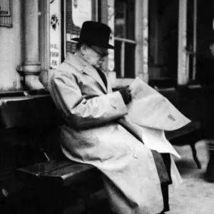 British Prime Minister Winston Churchill reading a newspaper on the platform at St British Prime Minister Winston Churchill reading a newspaper on the platform at St