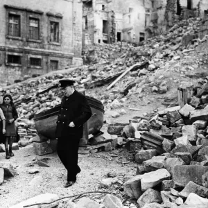 British Prime Minister Winston Churchill surveys the destruction in the dockyard area of British Prime Minister Winston Churchill surveys the destruction in the dockyard area of