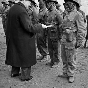 British Prime Minister Winston Churchill watches an exercise by troops on commando lines