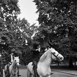 British rock group The Kinks pose on horses in the gardens opposite the Flaghouse in