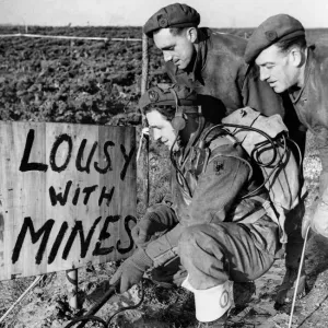 British sappers at work clearing away enemy mines in a field near the town of