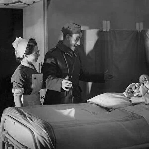 A British serviceman looks surprised as his wife presents him with a newborn baby