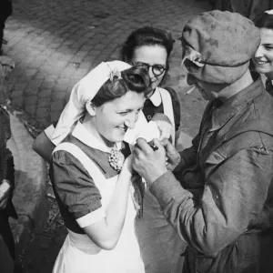 A British soldier autographs the cap of a Dutch nurse at Eindhoven as a souvenir of A British soldier autographs the cap of a Dutch nurse at Eindhoven as a souvenir of