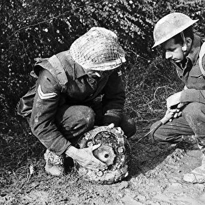 British soldiers defusing a land mine during WW2. 1944