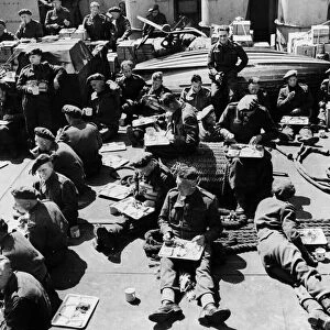 British troops with chicken, fruit salad, coffee and cream provided by the american crews