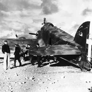 British troops examine the wreckage of an Italian S79 aircraft which landed on the edge British troops examine the wreckage of an Italian S79 aircraft which landed on the edge