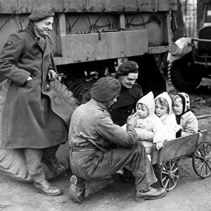 British troops with German children following the invasion of Germany in February 1945