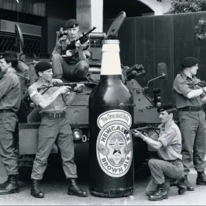 British troops guarding a 6 foot tall bottle of Newcastle brown ale standing in front of