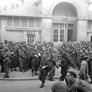British troops outside the bath house in a Normandy town in Northern France shor