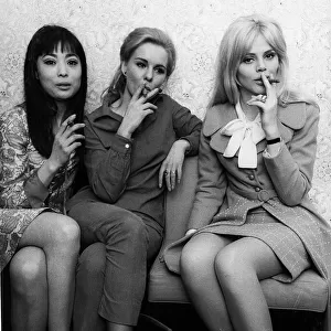 Britt Ekland (R) with Poulet Tu (L) and June Ritchie in 1966 smoking cigars