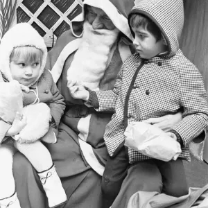 As her brother checks out Santa Clauss beard in Wellsteed department store in Broad As her brother checks out Santa Clauss beard in Wellsteed department store in Broad