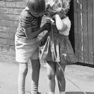 A brother comforts his sister during the long summer school holidays as she has no one to A brother comforts his sister during the long summer school holidays as she has no one to