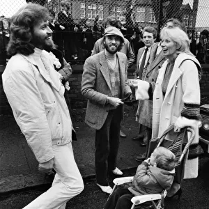 Brothers Barry and Maurice Gibbn of the Bee Gees pop group meet up with neighbours they