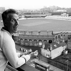 Bruce Forsyth Entertainer July 1965 looking over the balcony of his flat which