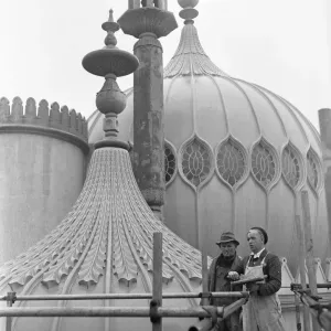 Builders who are involved in the restoration of Brighton Pavilion seen here on the roof