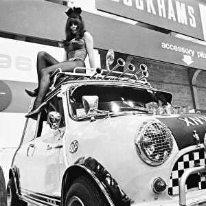 Bunny girl drapped over mini car at Motor Show at Horticultural Hall 2nd January 1968