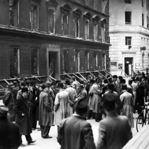 Business men from bombed out offices gather in the street to transact business Business men from bombed out offices gather in the street to transact business