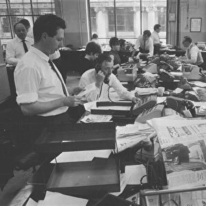 Busy scenes on the Daily Herald news desk, 1964