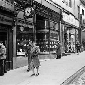 A busy shopping street in Edinburgh, showing the clockmakers James Ritchie & Son who A busy shopping street in Edinburgh, showing the clockmakers James Ritchie & Son who