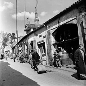 Busy street scene with local transporting their goods in a Cyprus town