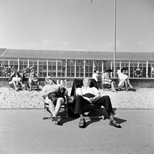 Butlins Holiday Camp at Bognor a couple sleeping in a deckchair with their dog
