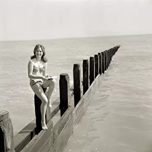 Butlins Holiday Camp at Bognor A young woman wearing a bikini sitting on a barrier