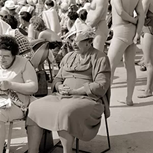 Butlins Holiday Camp in Minehead An elderly lady sitting on a chair wearing paper