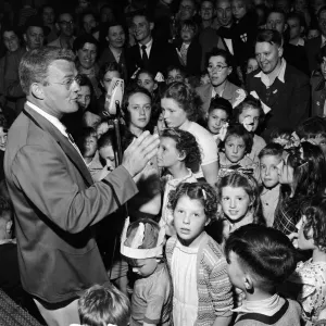 A Butlins Redcoat entertaining families at a Butlins Holiday Camp. June 1954 A Butlins Redcoat entertaining families at a Butlins Holiday Camp. June 1954