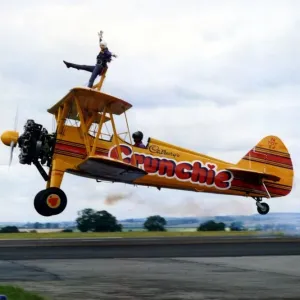 A Cadburys Crunchie Boeing-Stearman Model 75 biplane, with wing walker onboard A Cadburys Crunchie Boeing-Stearman Model 75 biplane, with wing walker onboard