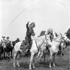 Cal McAndrew Print: A Man on Horseback with Lasso and Native Dressed Woman