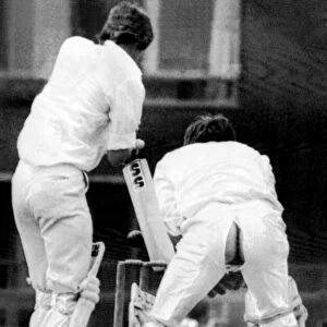 Cambridge University wicket keeper Peter Cottrell having some trouser problems during