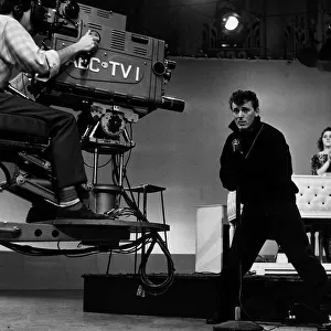 The camera swings in to record American Fifties Sixties pop singer Gene Vincent