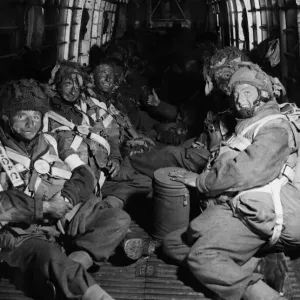 Camouflaged with blackened faces, paratroopers take up their position in their aircraft Camouflaged with blackened faces, paratroopers take up their position in their aircraft