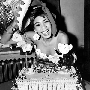Cardiff-born singer Shirley Bassey is pictured celebrating her 19th birthday with a cake