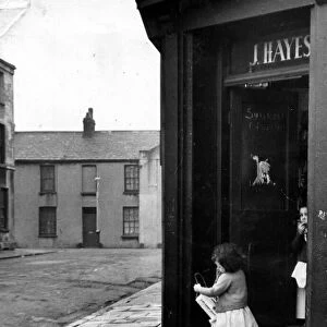 Cardiff - Old - A young child leaves a typical Cardiff corner shop in Butetown