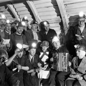 Carol service by miners 600 ft down. An accordion play and miners voices are raised in Carol service by miners 600 ft down. An accordion play and miners voices are raised in