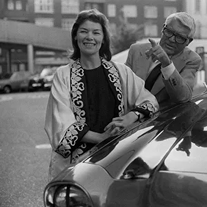 Cary Grant and Glenda Jackson standing beside car 5 / 6 / 75