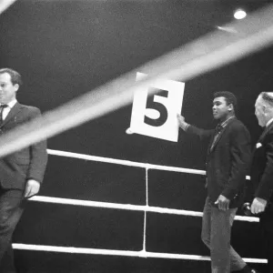 Cassisus Clay (Muhammad Ali) seen here holding the 5th round card during the fight Cassisus Clay (Muhammad Ali) seen here holding the 5th round card during the fight