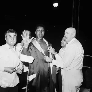 Cassius Clay aka (Muhammad Ali) vs Henry Cooper in their first fight at Wembley Stadium Cassius Clay aka (Muhammad Ali) vs Henry Cooper in their first fight at Wembley Stadium